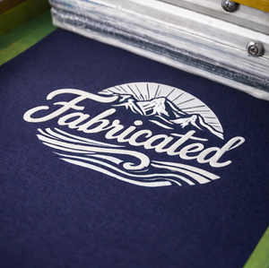 Fabricated logo screen printed on a garment
